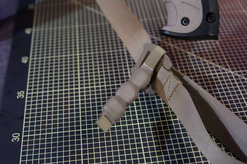 Agilite tactical sling adjustment pull tab detail, showing quick-adjust handle for rapid length regulation