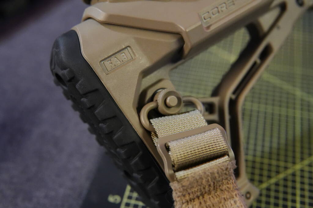 FAB Defense buttstock with QD quick-detach sling mount and tactical sling attachment, close-up detail