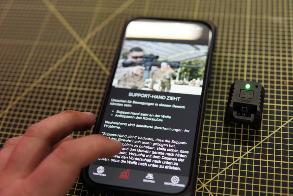 Mantis X10 training feedback displayed on a smartphone with the connected sensor placed beside it.