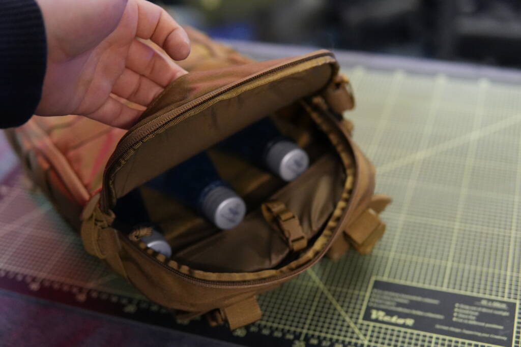 Helikon-Tex Guardian Small Pack opened, showing three water bottles stored inside instead of a hydration bladder.