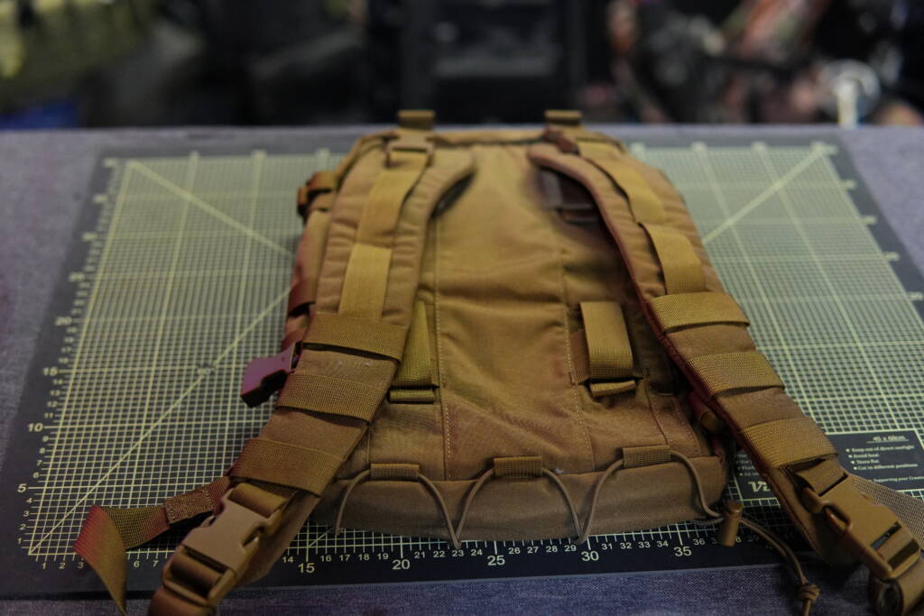 Rear view of the Helikon-Tex Guardian Small Pack showing removable shoulder straps and MOLLE attachment system.