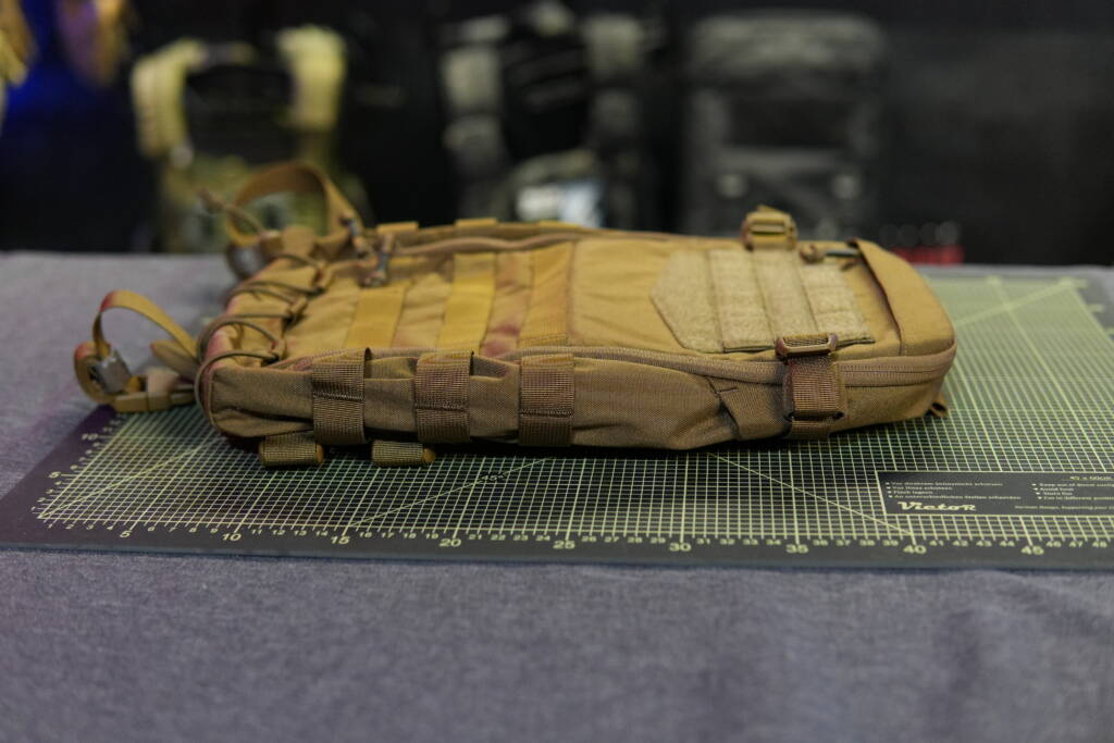 Helikon-Tex Guardian Small Pack lying flat on a cutting mat without contents, showing low-profile design.